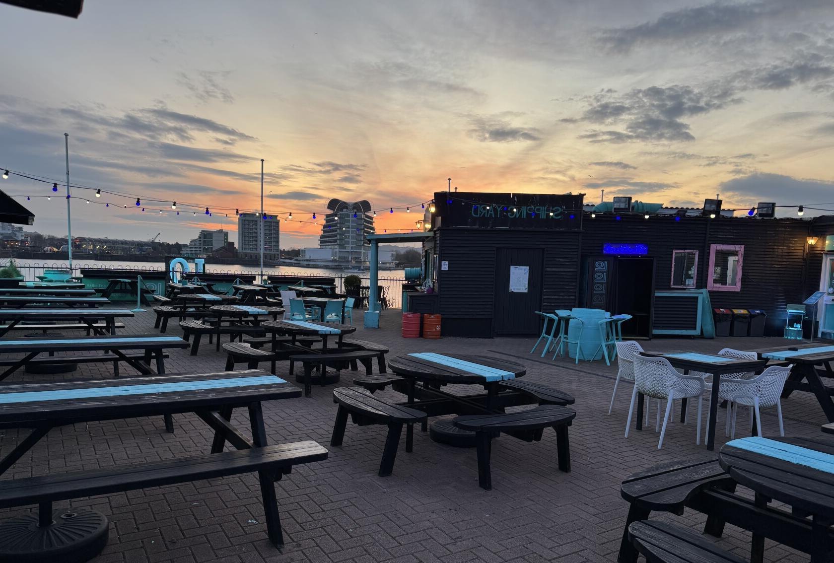Lo Lounge waterfront outdoor seating at sunset